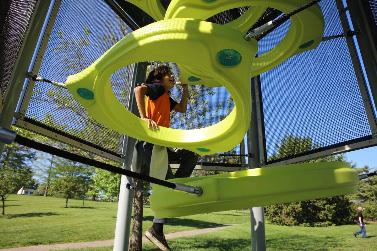Cash, a Long Elementary fourth grader, climbs the obstacle course at Crestwood Park.