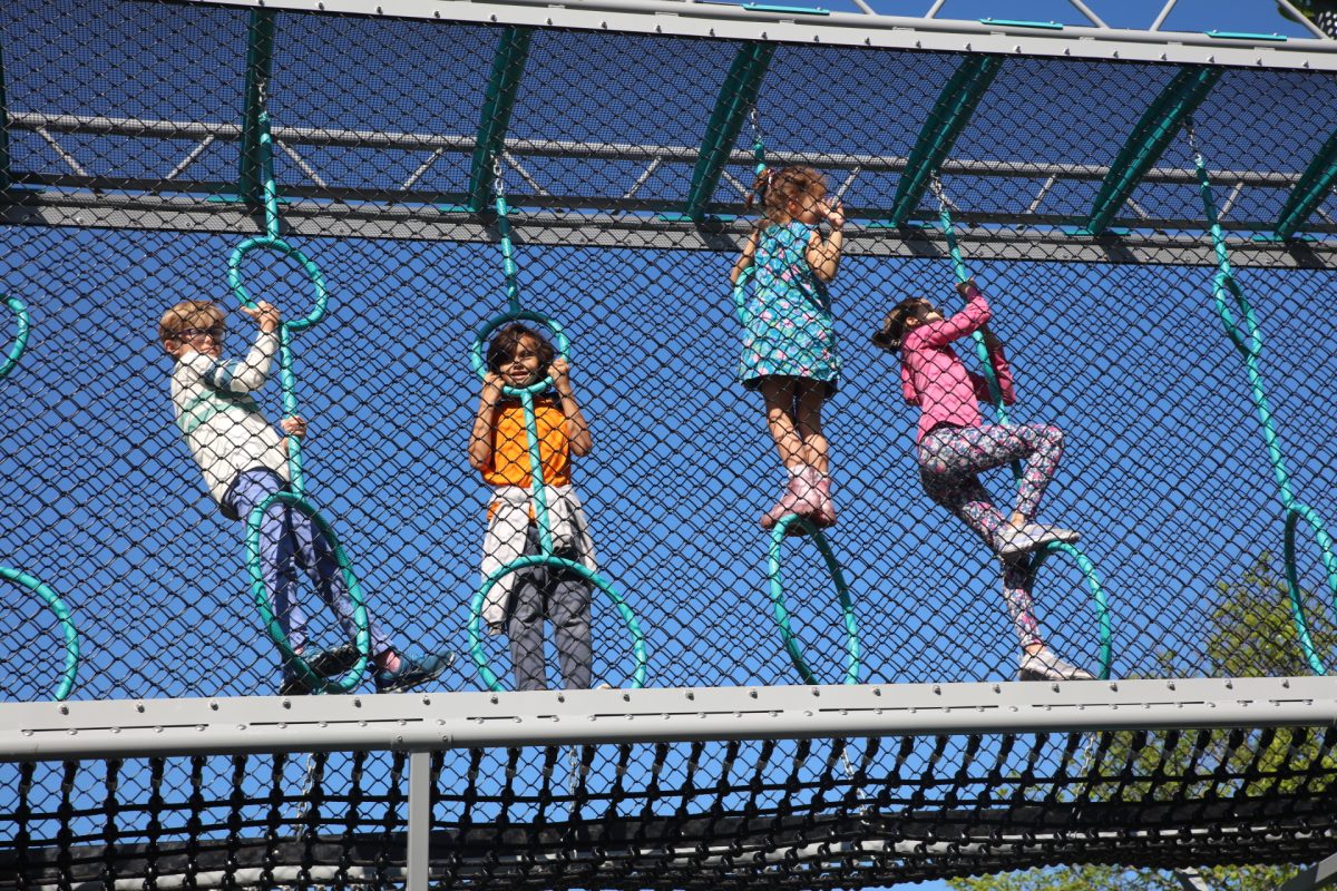 Long Elementary students climb through the obstacle course. 