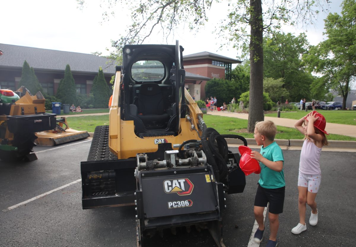 Two young attendees gasp at the sight of a CAT.