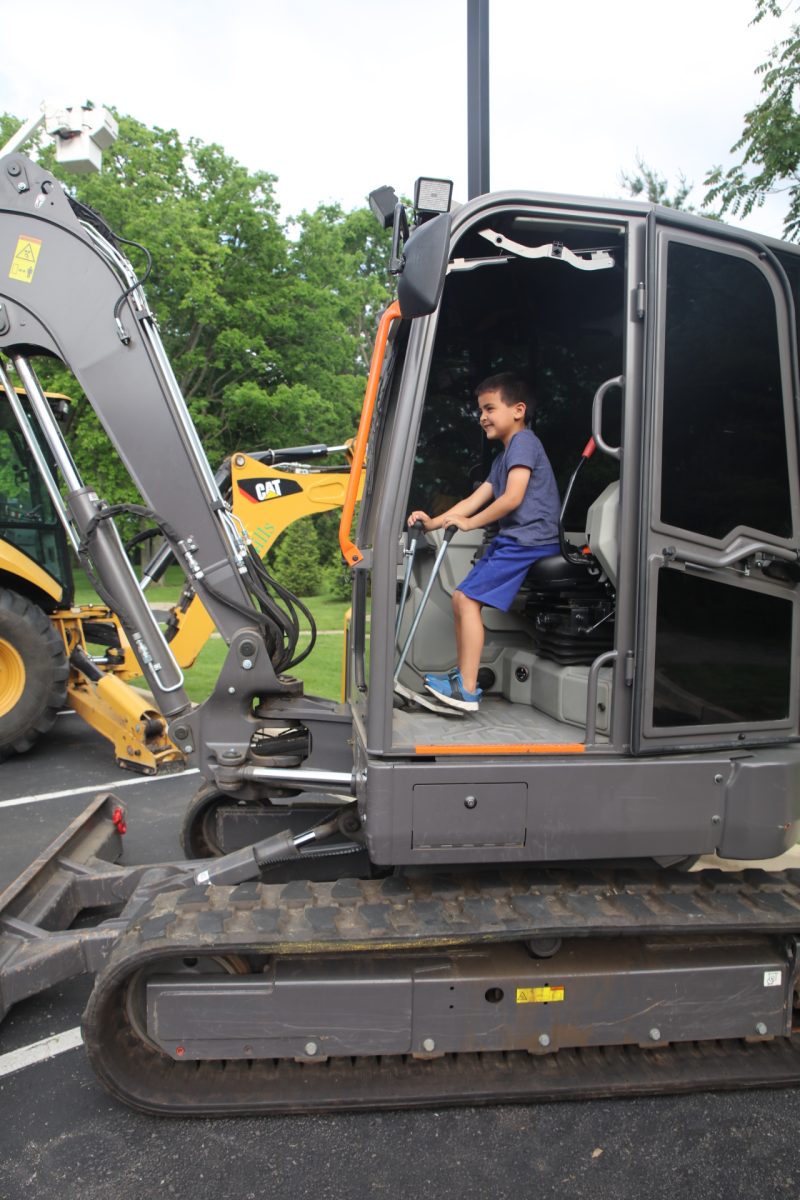 A boy pretends to drive.
