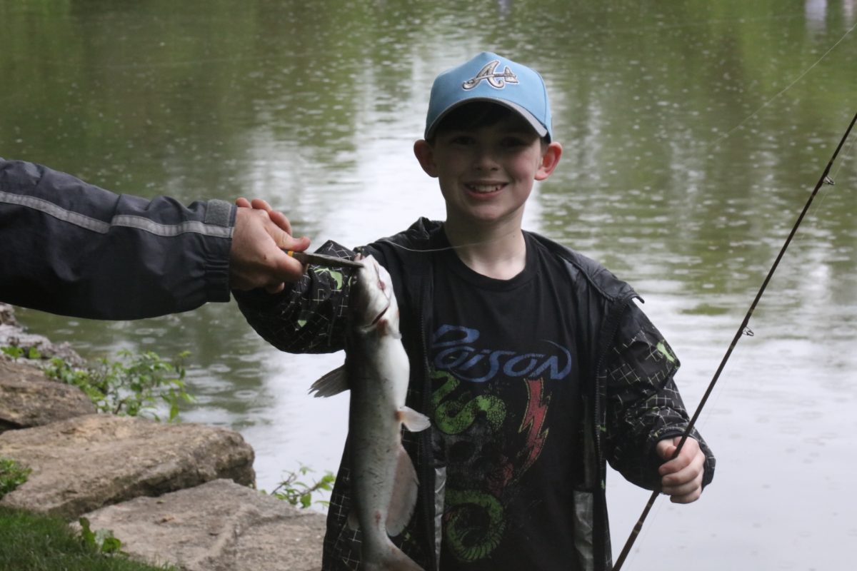 A young fishing derby attendee shows off his catch.