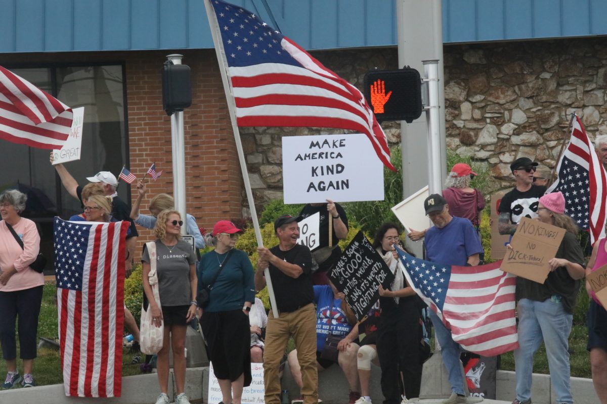 Protestors wave American flags.