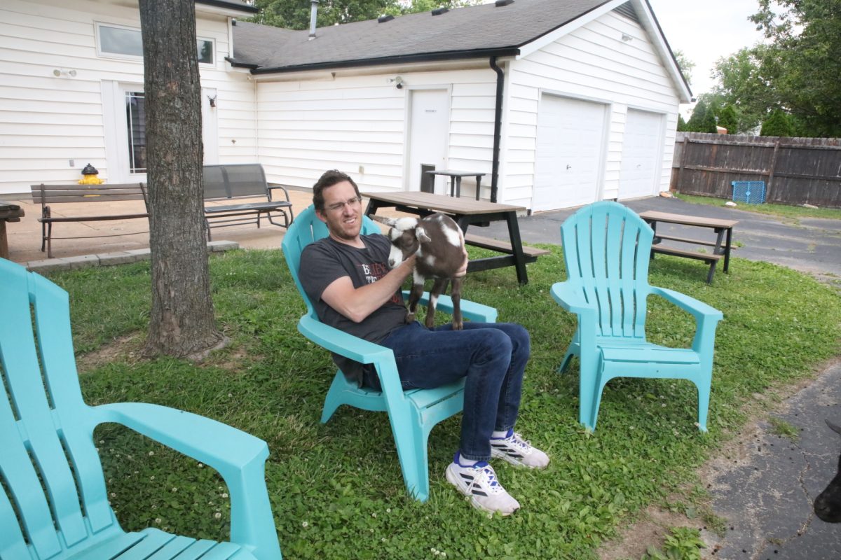Tim Pauk holds Mr. Pickles. Mr. Pickles is the goat they most often take on Goat Grams.