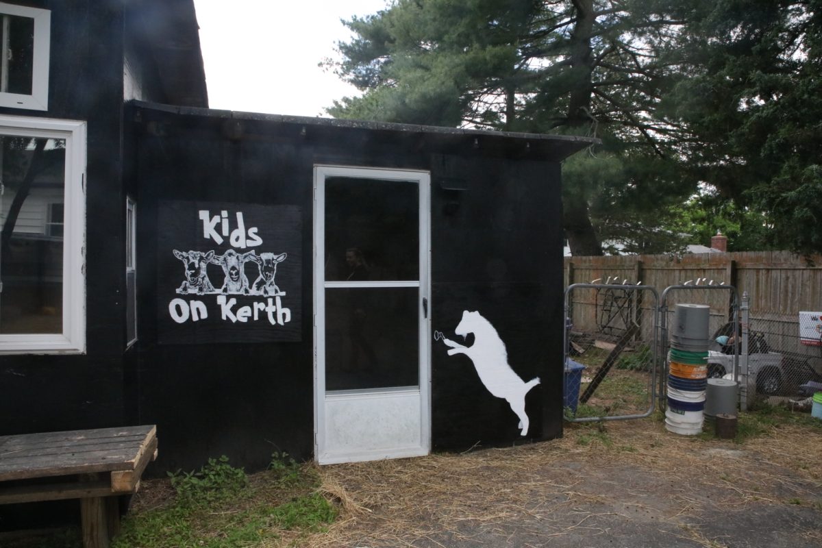 Kids on Kerth is the name of the business Tim and Hannah run with their herd. They recently painted this sign onto their barn, which used to be a chicken coop, along with an illustration of one of their goats, Candy — who they call "their escape artist" — opening the door.