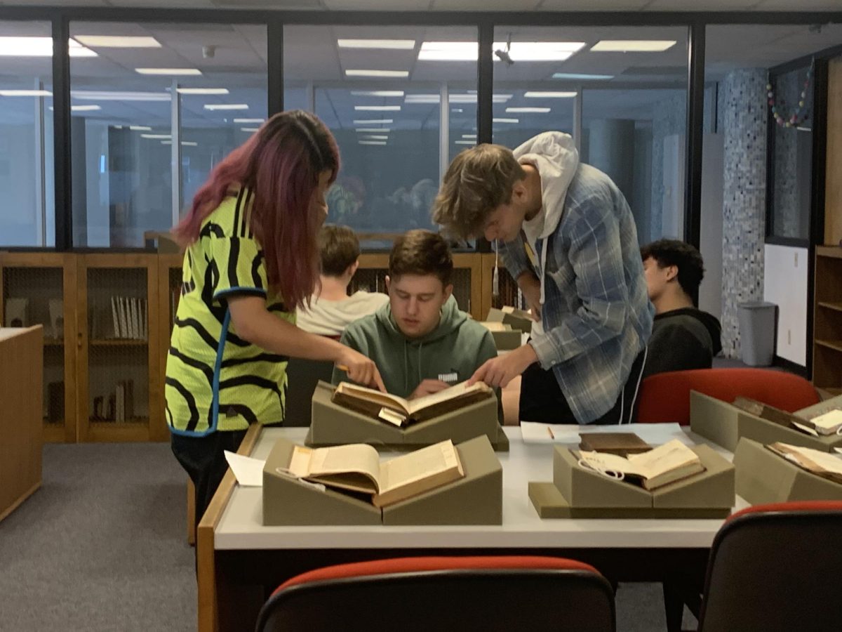 Affton High School students visit the SLU rare books library where they observe centuries-old texts on the history of seafaring. Photo courtesy of SLU's 1818 ACCP newsletter.