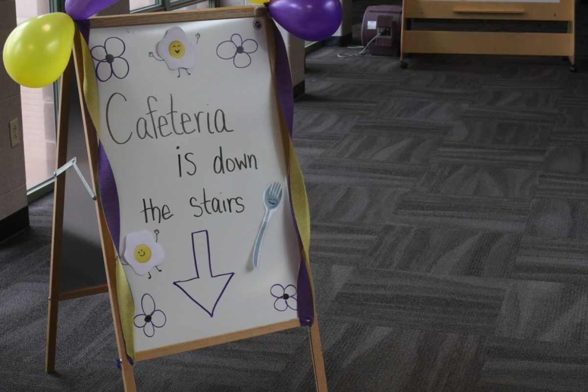 A sign directing new students to the cafeteria for breakfast at the 2025 Hagemann Kindergarten Breakfast, held July 31 at the elementary school. 