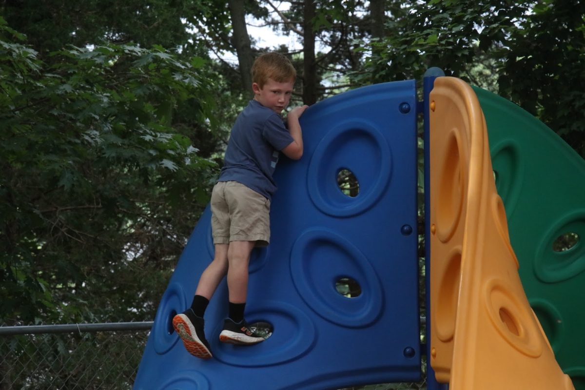 A child climbs a jungle gym structure.