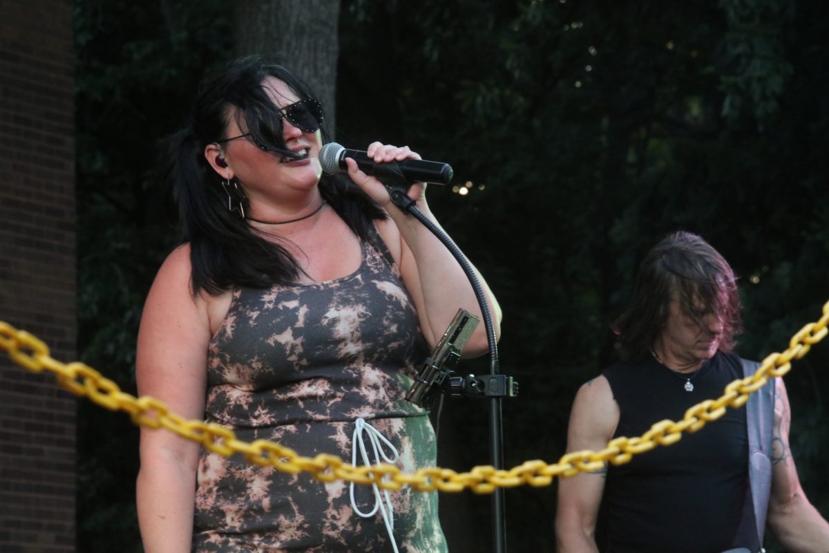 Real Rock Revival's lead singer stands singing towards the audience.