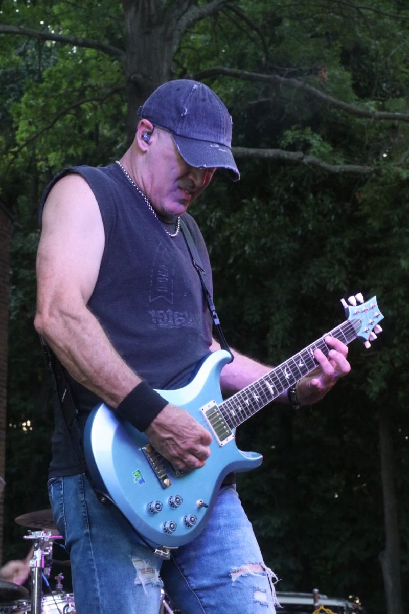 The lead guitarist of Real Rock Revival rocks out on his guitar.