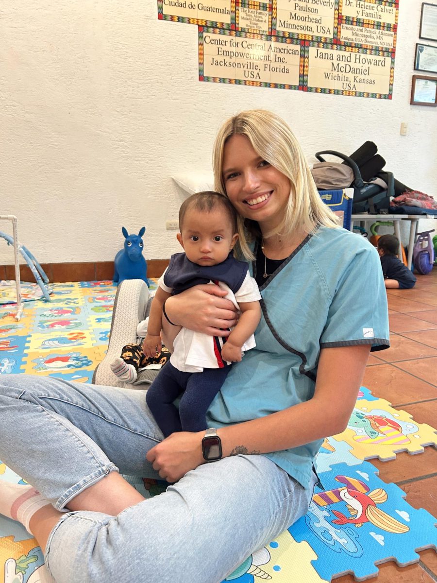 Sarah Rivers smiles, holding a child on her volunteer trip in Guatemala. While there, she helped those in need, including caring for infants recovering from malnutrition. Photo courtesy of Sarah Rivers.