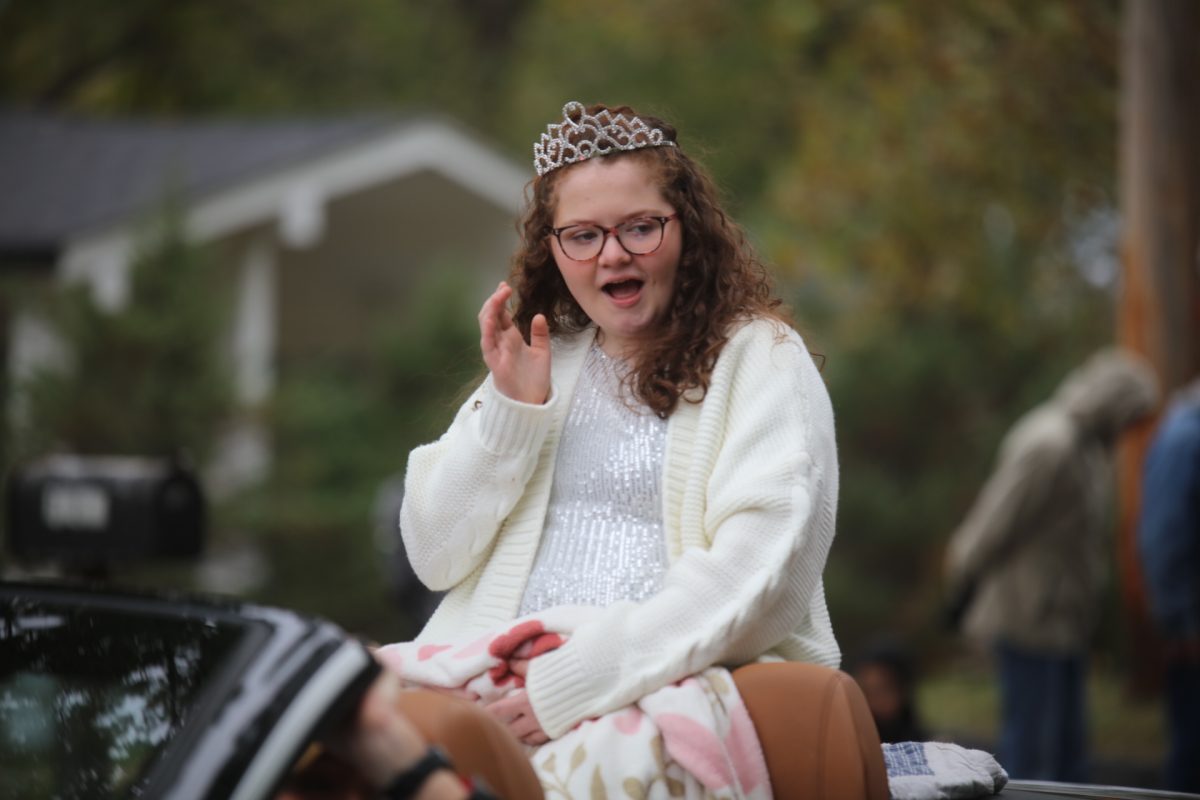 Kensley Stone, who was recently crowned a Missouri Queen and National Princess in the Miss Amazing pageant, waves to onlookers as she participates in the SunCrest Fest parade.