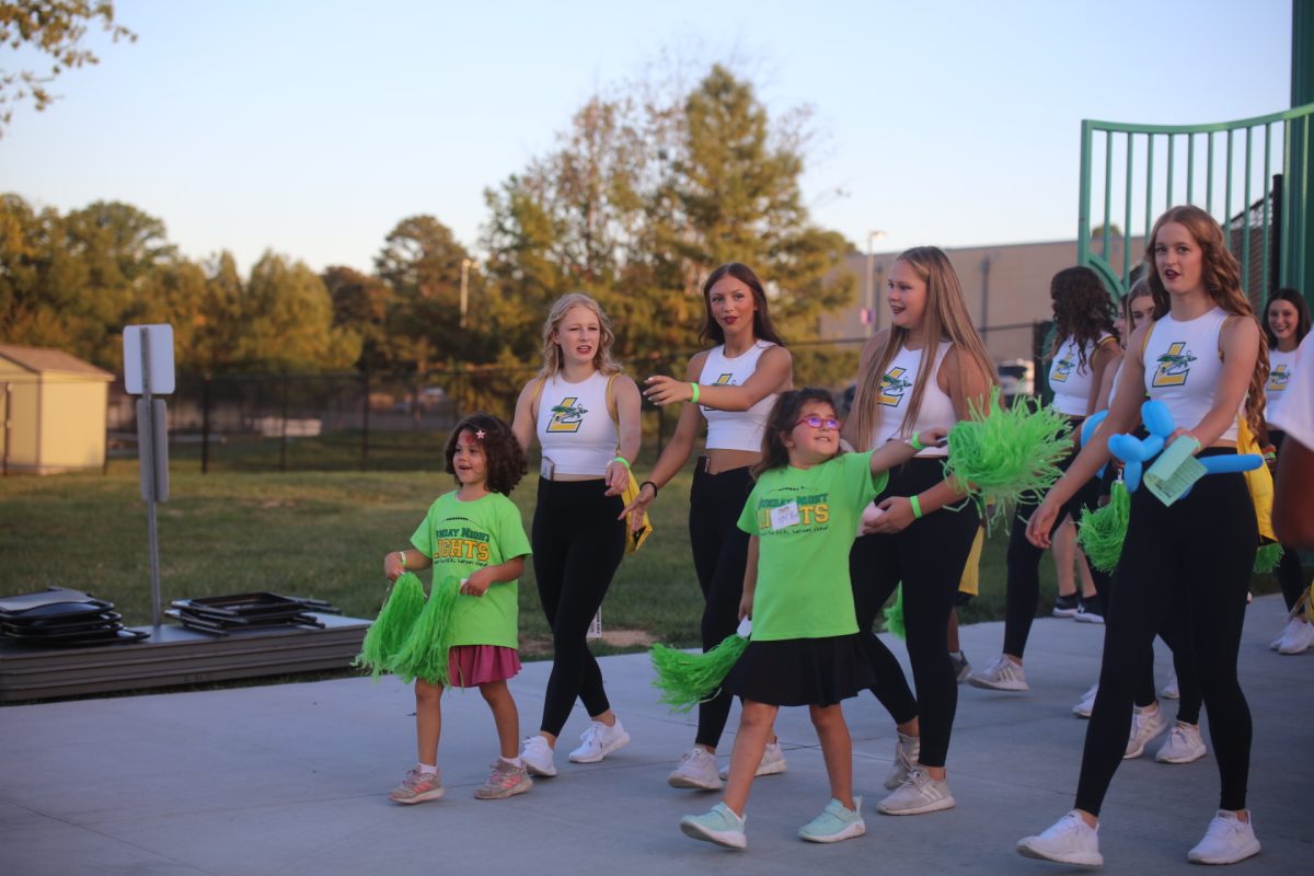 Children entered with LHS students in a small parade prior to the start of the flag football game.