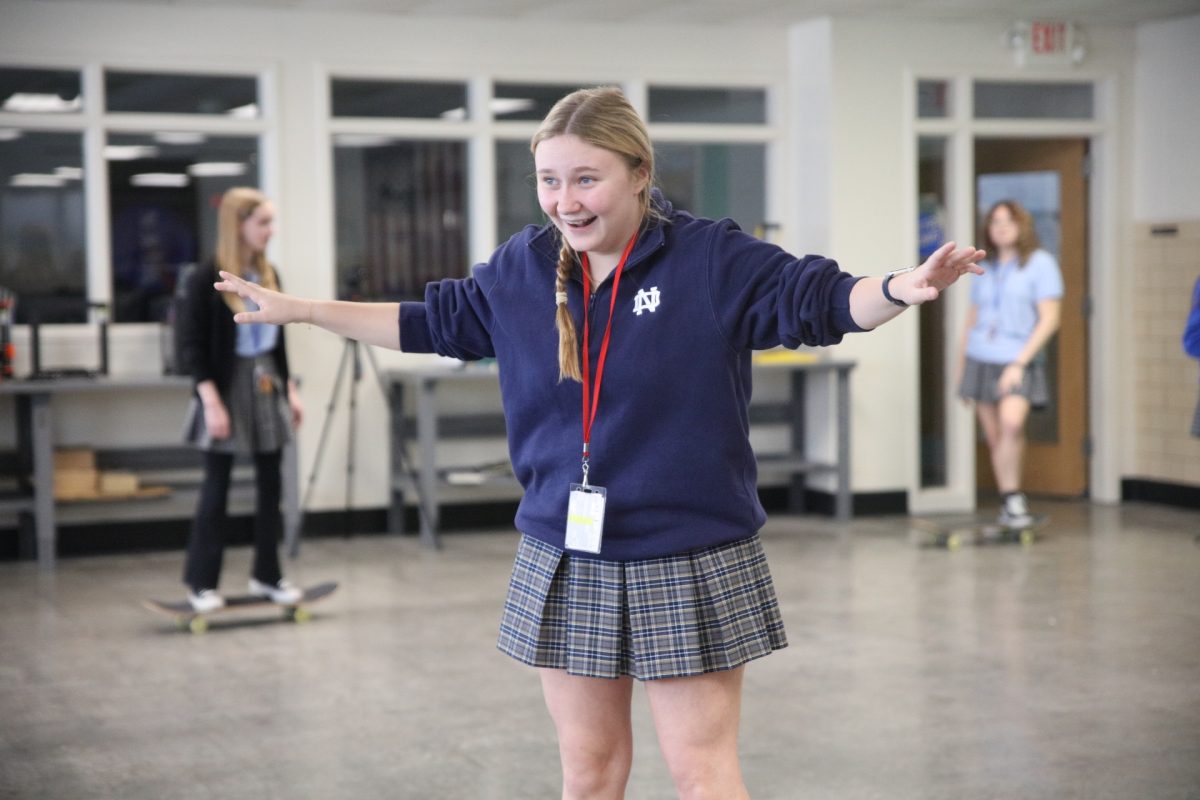 Emily Storey gleefully looks at her friends, amazed at her balance.