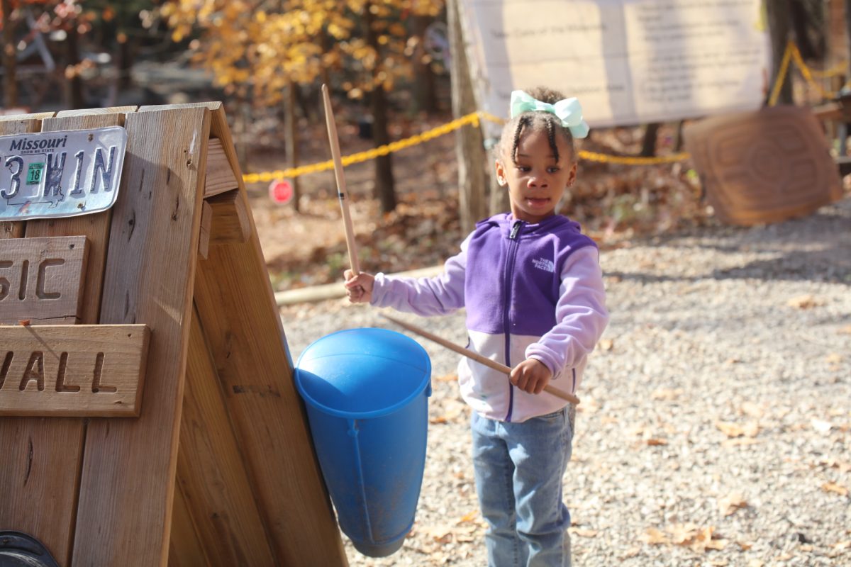 A student from John Cary Early Childhood Center drums, practicing her musical skills.