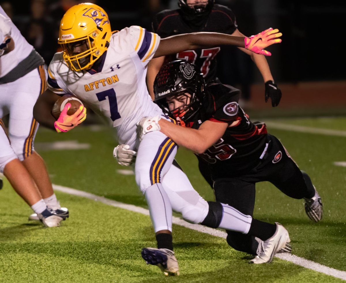 Affton running back Brendan Mitchell attempts to run with the ball despite a Union player tackling him. The teams faced off on Oct. 30, with Union coming out victorious.