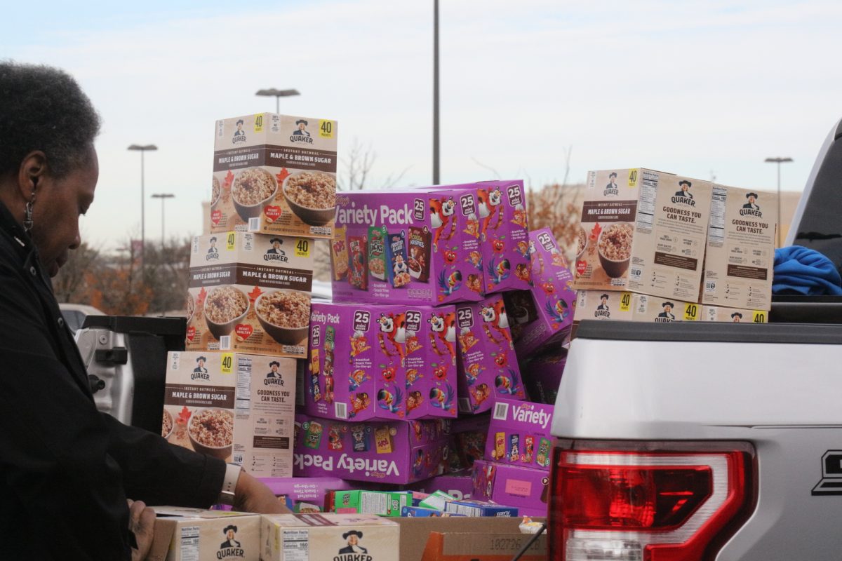 Food is piled high in the back of a truck, waiting to be distributed by volunteers.