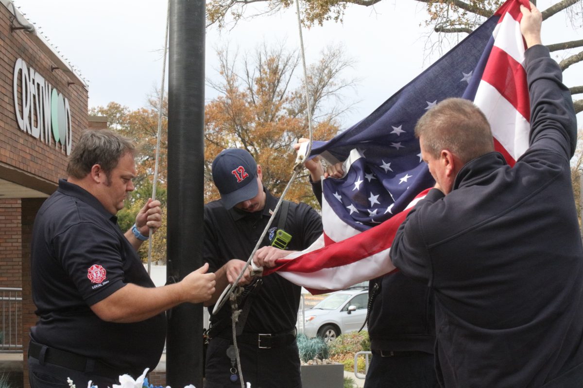 Firefighters from the Crestwood Fire Department raise the U.S. flag during the 2025 Veterans Day ceremony.