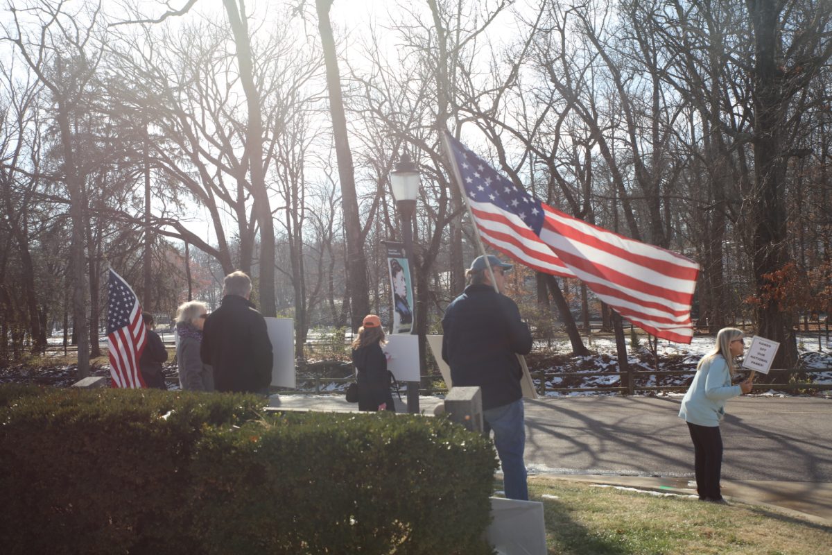 A local group stands outside by the gates of the Ulysses S. Grant National Historic Site, 7400 Grant Road, on Dec. 6, holding signs that read "Protect Our Parks" and "We (heart) Our Parks." This group has stood in front of the park every weekend since February to bring awareness to the negative changes that have occurred surrounding National Parks since President Donald Trump assumed office in January.