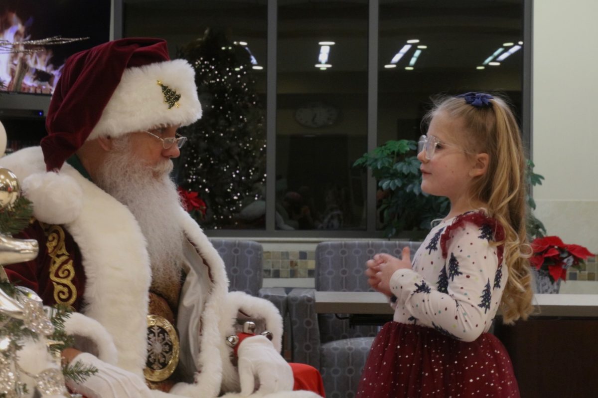 Santa tells a young attendee to sleep on Christmas Eve so she can get her presents. 
