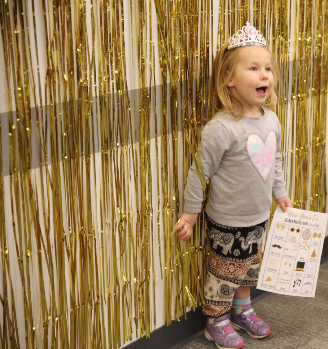 A wall covered in gold streamers made a festive photo backdrop.