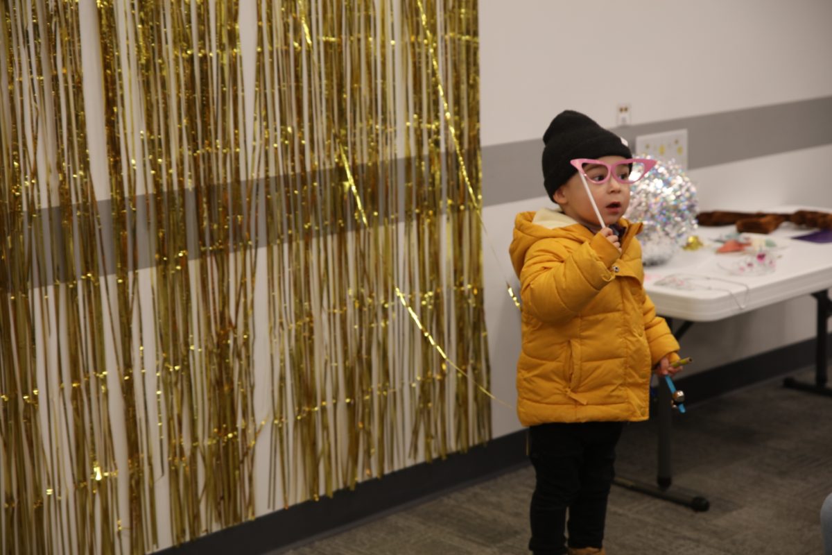A wall covered in gold streamers made a festive photo backdrop.