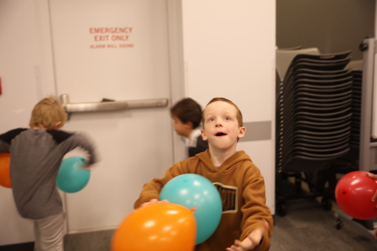 Attendees atempted to gather as many balloons from the noon balloon drop as possible.