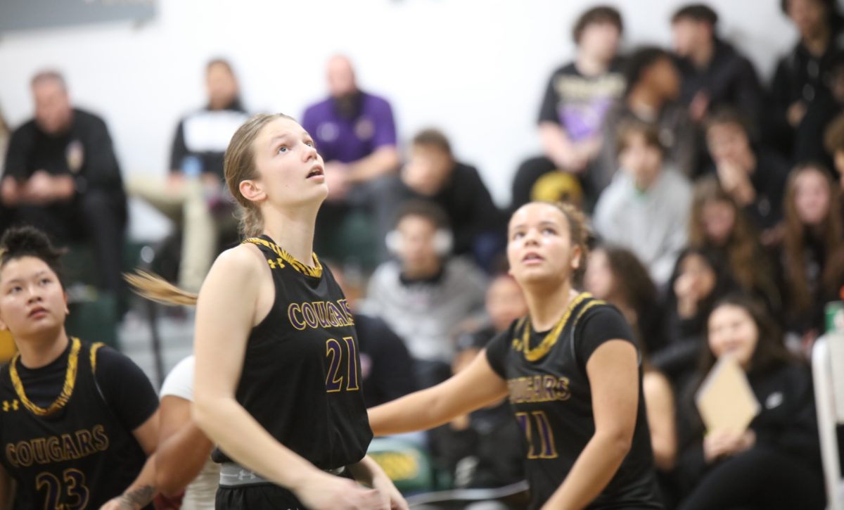 Affton players Carly Le, Elliana Casey and Phoenix Clark look to the scoreboard.