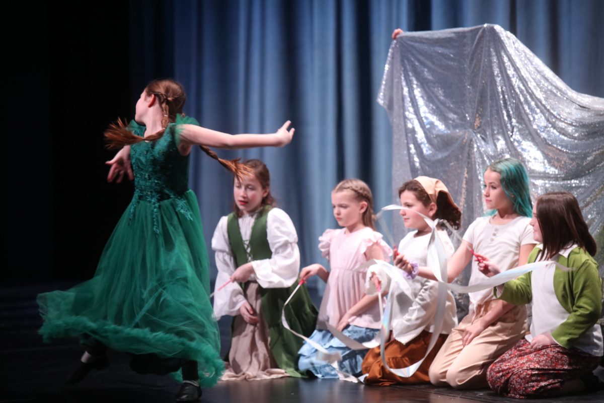 The Enchantress 
(Wilhemina Hoyt) twirls across the stage to curse the Beast, turning him into an animal.