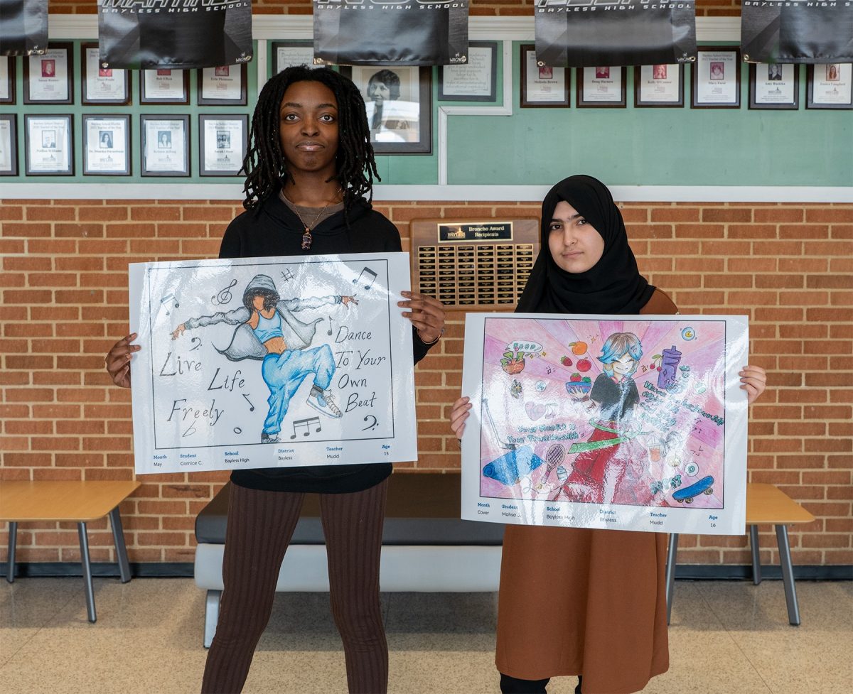 Bayless High School freshman Curnice Carter (left) and sophomore Mahsa Jalili (right) show off their artwork. The two pieces were chosen out of 779 submissions in this year's  St. Louis County Department of Public Health Healthy Living Calendar Contest. Photo courtesy of the Bayless School District.