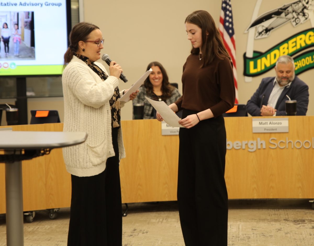 Stella Pellerito, Lindbergh Board of Education’s new student representative, takes an oath of office with the help of board secretary Julia Voss at the board's Jan. 22 meeting.