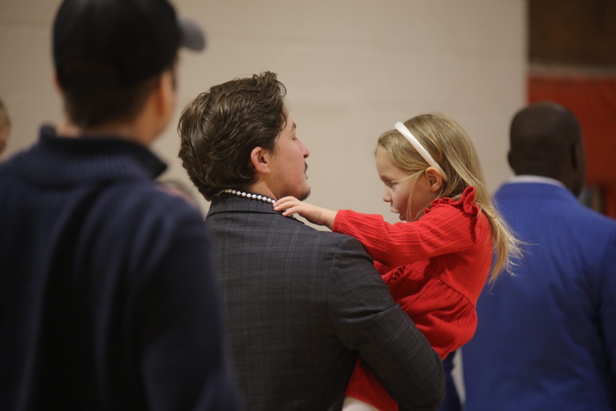 A father and daughter wait in line for food at the Sweetheart Dance. The proceeds from the dance went to the Whitecliff Summer Playhouse.