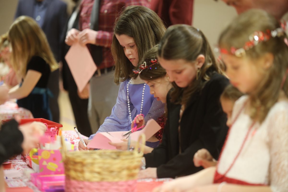 Girls make Valentine's cards for their loved ones at the craft table at the annual Crestwood Sweetheart Dance on Feb. 7.