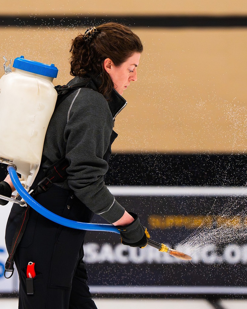 Notre dame alum Lauren Rich,  a member of the curling ice crew ifor the 2026 Winter Olympics, pebbling the curling ice. Photo courtesy of USA Curling / C Kerns Photography via Notre Dame High School.