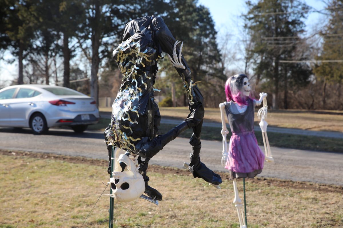 A figure skating skeleton, modeled after Ilia Malinin, does a backflip. This is the Pauks' second time setting up their skeletons for the Winter Olympics.