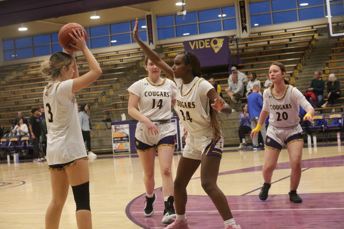 The Affton High School girls basketball team practices guarding while warming up before its game against Seckman.