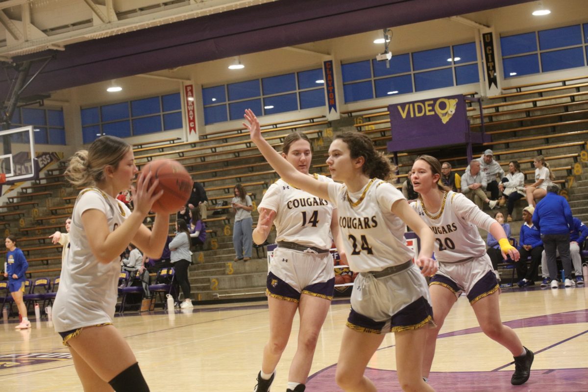 The Affton High School girls basketball team practices guarding while warming up before its game against Seckman.