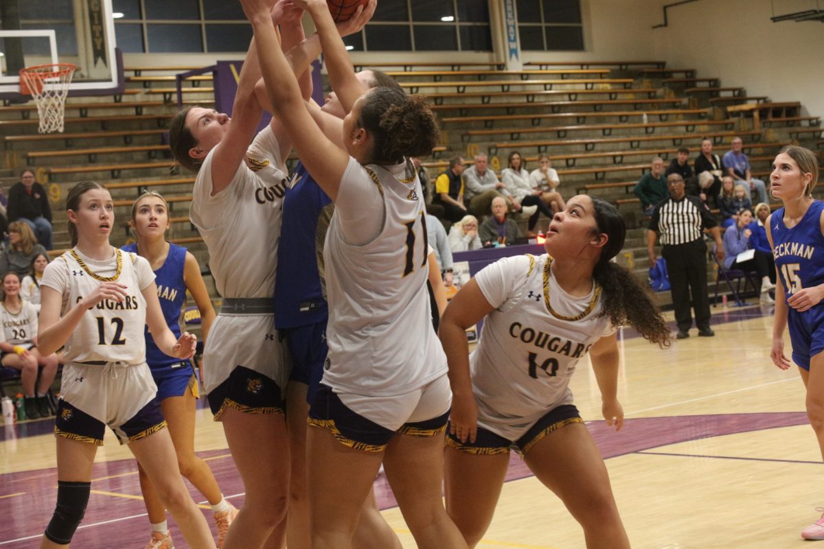 Affton's Katie Balinski and Phoenix Clark surround a Seckman player in an attempt to secure the rebound first. Lillian Hutchison and Kaleia Shae watch their teammates in anticipation.