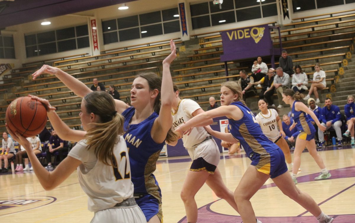 Affton senior Lillian Hutchison, ball in hand, attempts to pass to a teammate while two Seckman players 