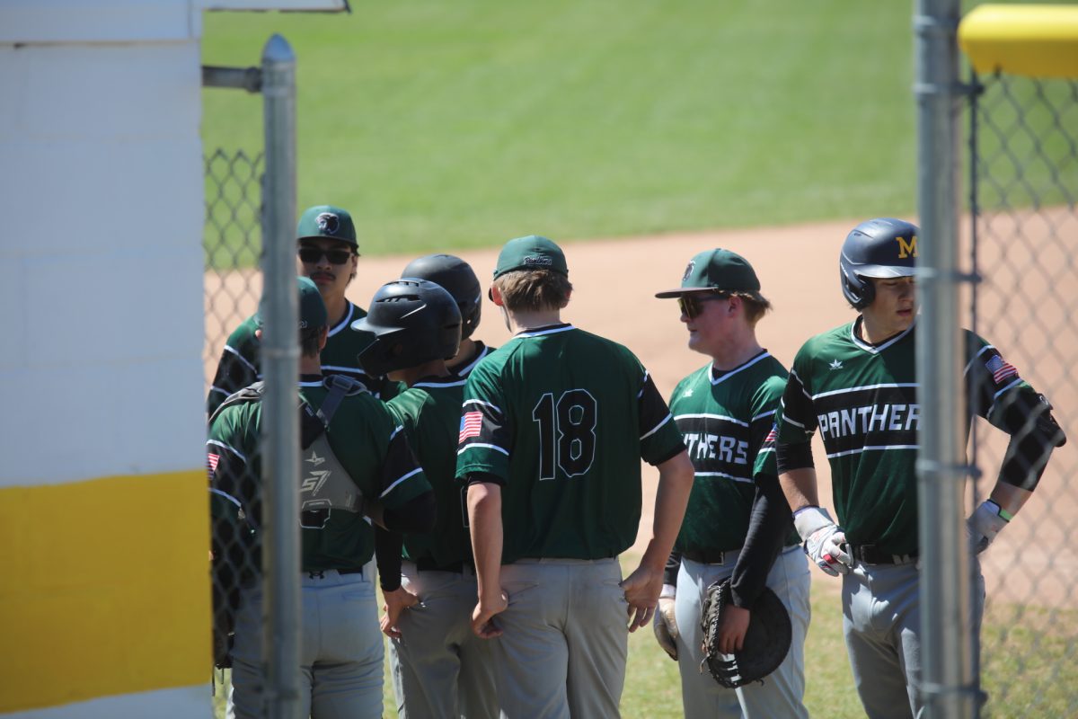 The Mehlville Panthers talk as a team on April 6 before they head onto the field to face off against the Oakville Tigers.