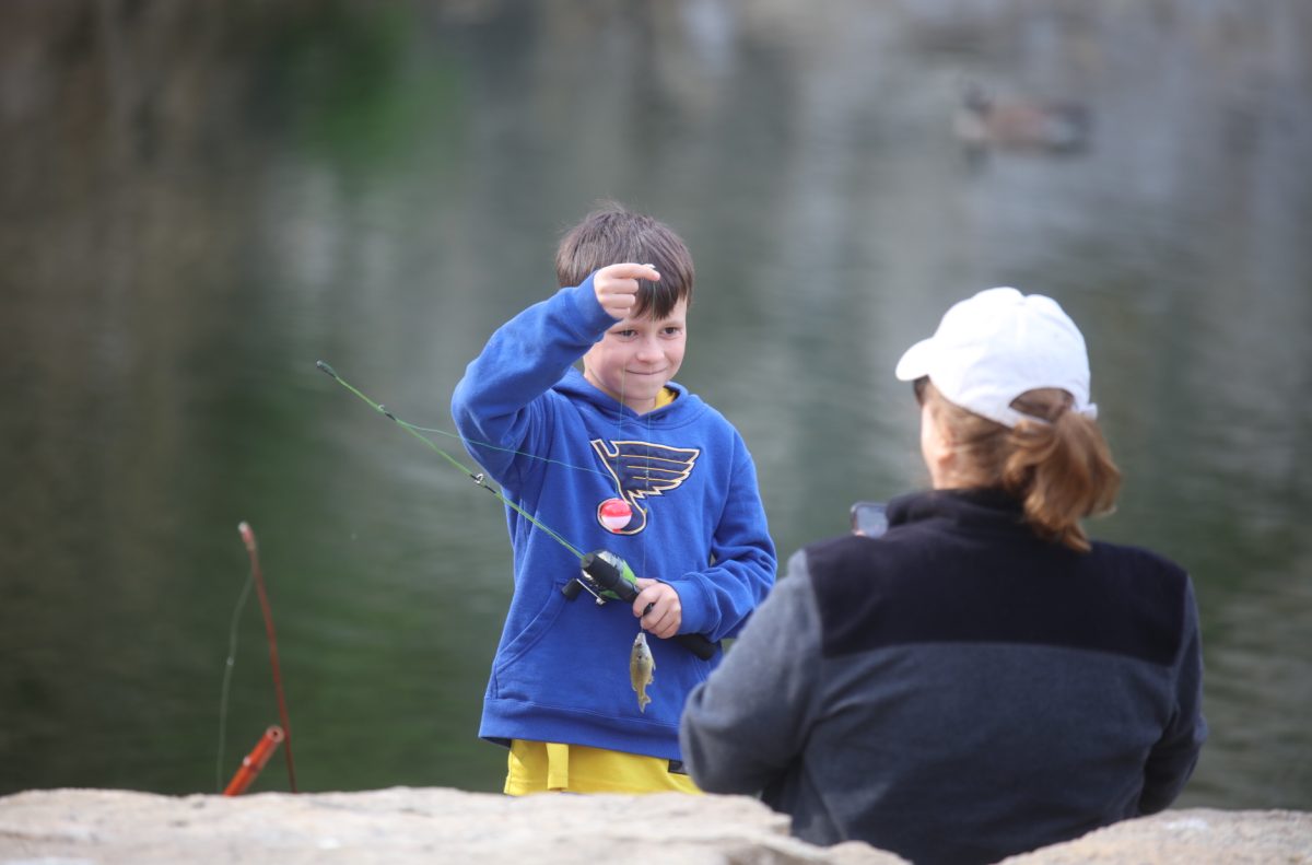 A child lifts a fish on his string. He caught the fish at the April 11 fishing derby at Whitecliff Quarry, where children won prizes in various categories.