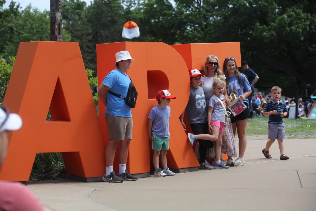A family poses for a photo beside the “ART” sign at Laumeier Sculpture Park’s 2026 art fair.