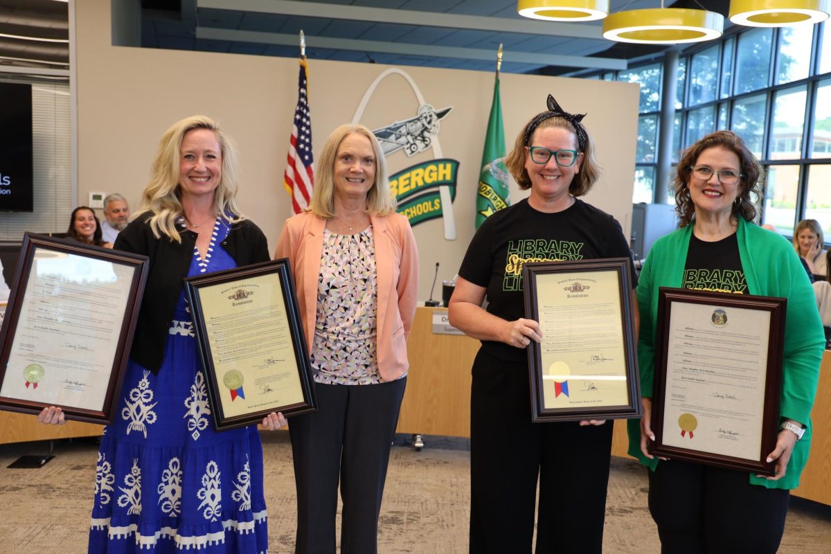 The Missouri Department of Elementary and Secondary Education recognized two Lindbergh libraries as 2026 Exemplary School Libraries during the May 14 Lindbergh Schools Board of Education meeting. Pictured (L-R): Kristin Hill, Dressel Elementary School library media specialist; Lisa Scroggs, DESE director of secondary literacy; Emily Hines, Sperreng Middle School library media specialist, and Emily Cook, Sperreng library assistant. Photo courtesy of Beth Johnston.