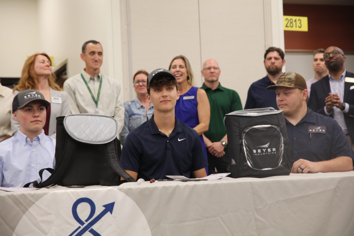 Lindbergh's Nick Weber (middle) signed with Seyer Industries.
