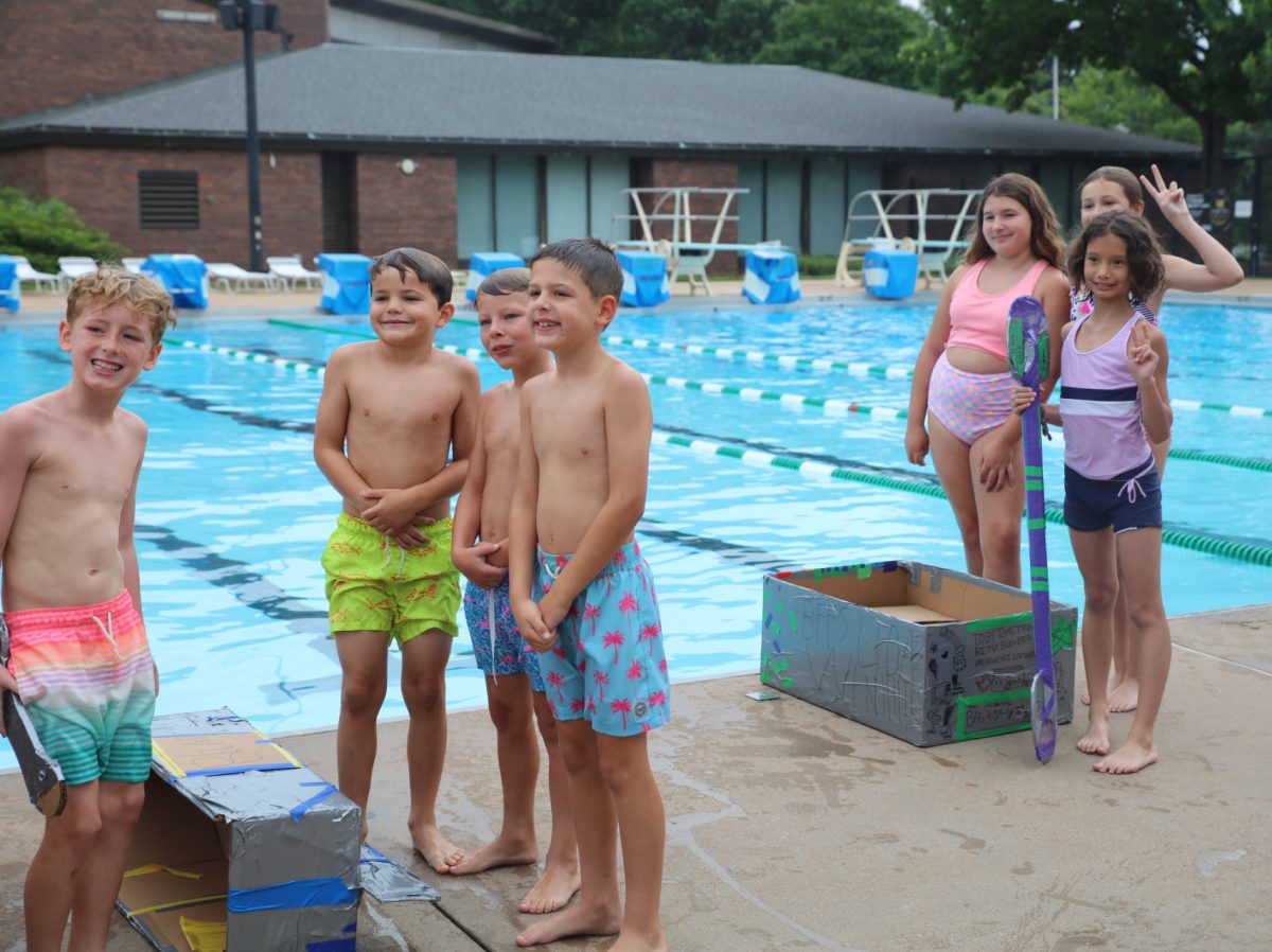 Racers pose with their handmade boats before the 2026 Cardboard Boat Regatta competition.