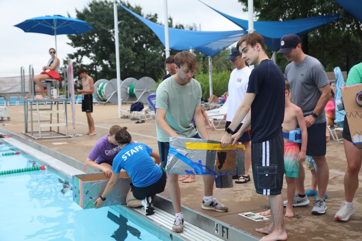 Crestwood Aquatic Center lifeguards set up the next race by placing the competitors' boats in the pool.