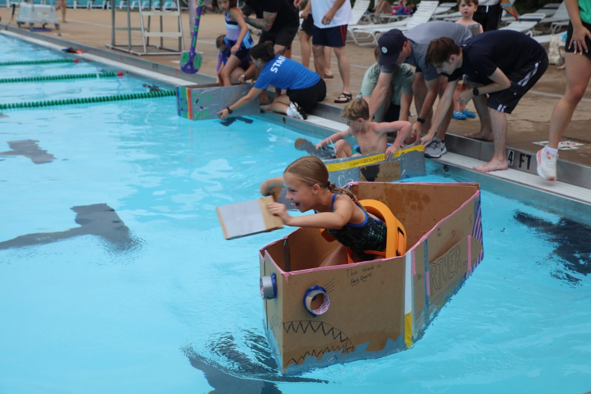Racers begin, paddling down the pool.