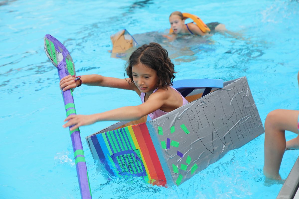 Ceci C. paddles to victory, winning her division, at Crestwood's 2026 Cardboard Boat Regatta.