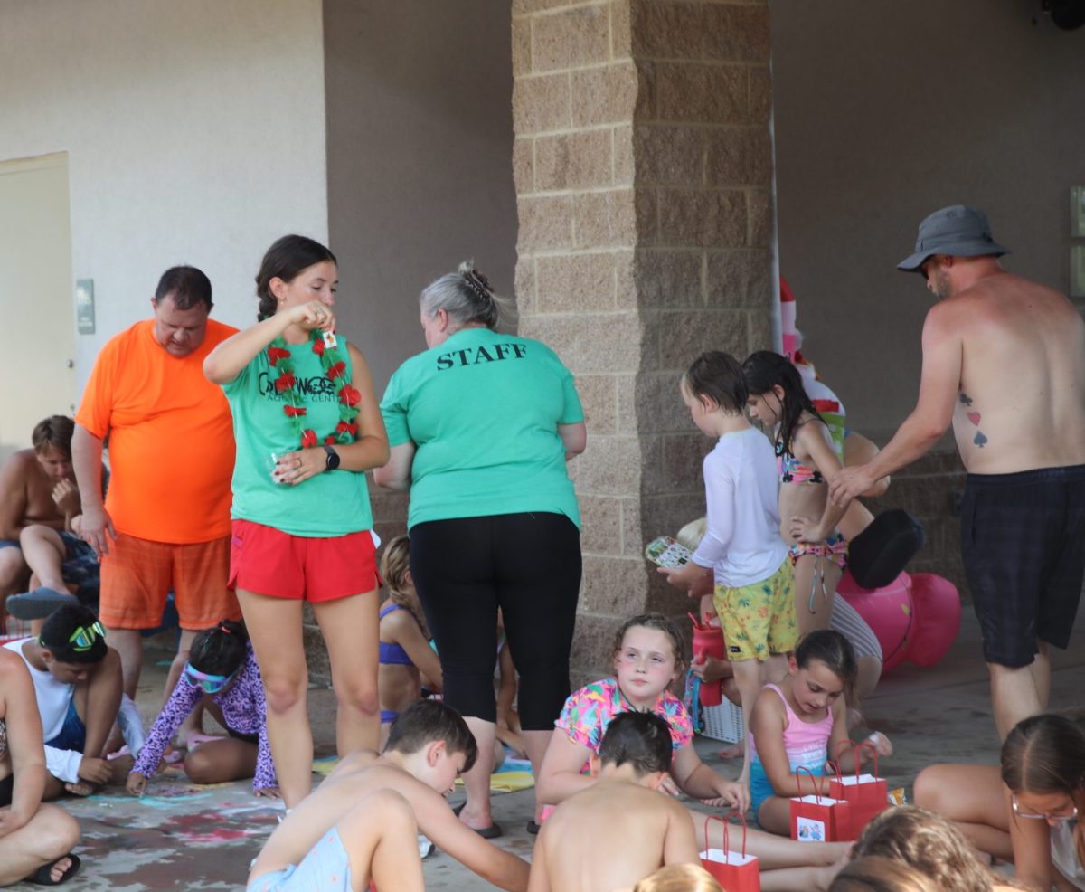 A Crestwood Aquatic Center lifeguard hand out prizes during a holiday game.