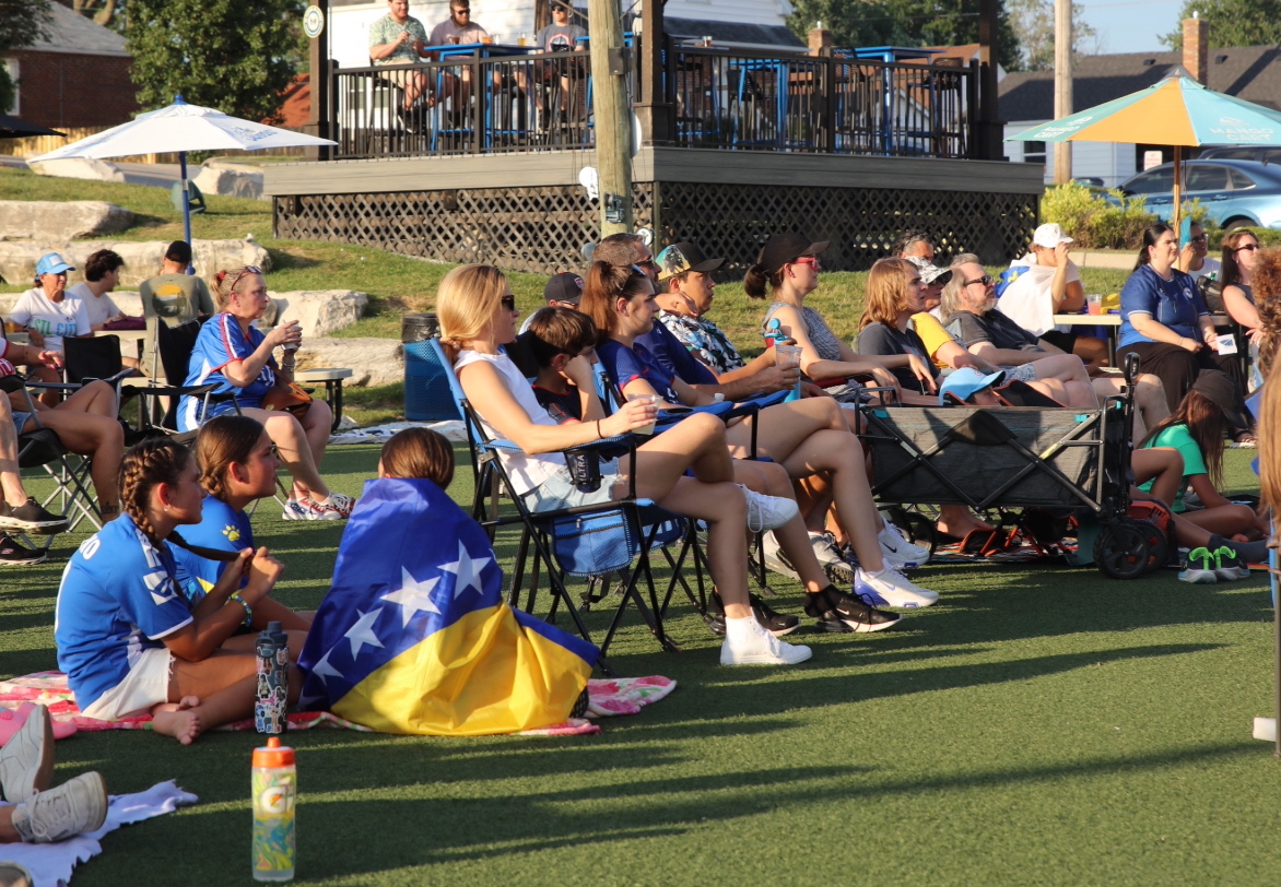 On July 1, 9 Mile Garden was filled with lawn chairs and soccer fans, gathered together to watch the USA take on Bosnia and Herzegovina in the FIFA World Cup. Pictured above, young fans wrapped in the Bosnia and Herzegovina flag.