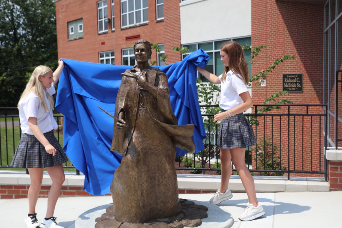 Notre Dame High School students unveil a sculpture of Caroline Gerhardinger, also known as Mary Theresa of Jesus, who founded the School Sisters of Notre Dame.
